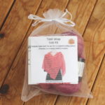 Knit kit packaged in a sheer organza drawstring bag
